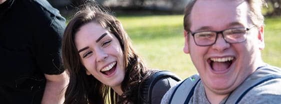 Two FLCC students laughing and enjoying themselves outside on FLCC's campus.
