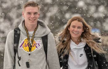 FLCC students walking at the Canandaigua Campus as snow flurries fall