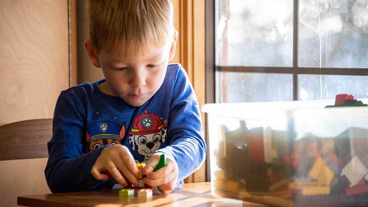 A child building Legos.