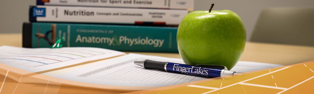 Nutrition, anatomy and physiology textbooks featured with an apple, pen, and notepaper