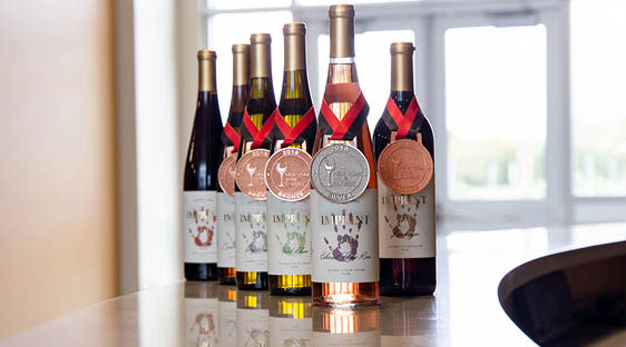 The 2017 Imprint vintage displayed with one silver and four bronze medals from the New York Wine Classic.