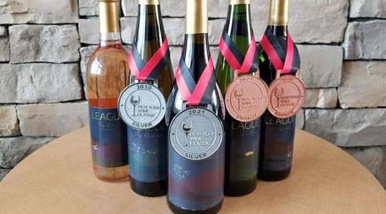 The 2018 League vintage displayed with one gold, one silver, and two bronze medals from the New York Wine Classic.
